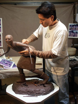 Joe Cajero works on one of his koshare pieces, a jester figure used in the sacred dances.